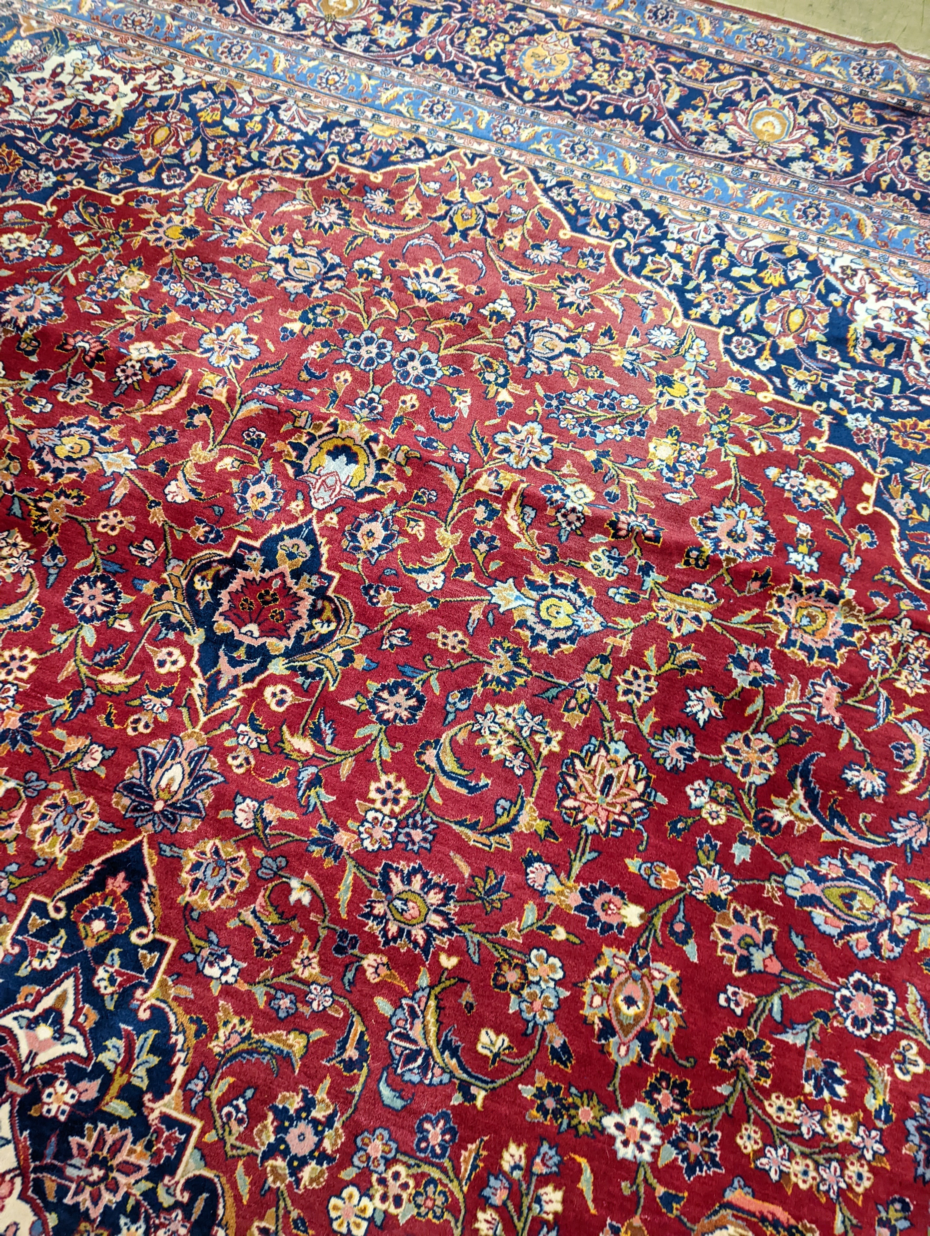 A large Tabriz red ground floral carpet, 540 x 350cm